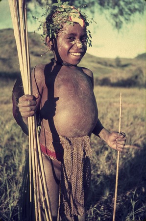 Kewa child, future warrior perhaps, young boy carries sticks