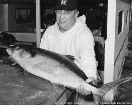 Man holding yellowtail tuna
