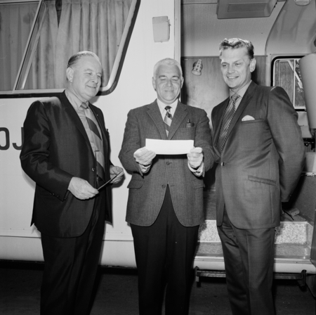 Sears Roebuck Company representatives awarding UC San Diego Chancellor William J. McGill (center) a check to pay for a new...
