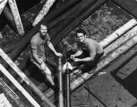 Left to right: Ralph Stephens and Robert G. Goldsborough working in the down-hole seismic area connecting oblique cable ab...