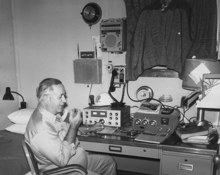 Lloyd Dill, a captain on the D/V Glomar Challenger (ship), working in the weather radio room aboard the ship during one of...