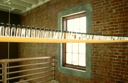 30 Years 21 Minutes 17 Tapes: hanging shelf with bottles