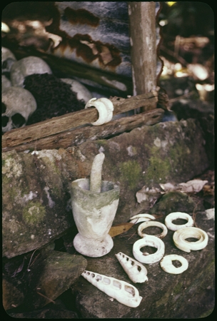 Shrine with shell jewelry, skulls, mortar and pestle