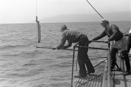 Richard H. Fleming and Martin Wiggo Johnson (in hat), with Nansen bottle on board the R/V Scripps