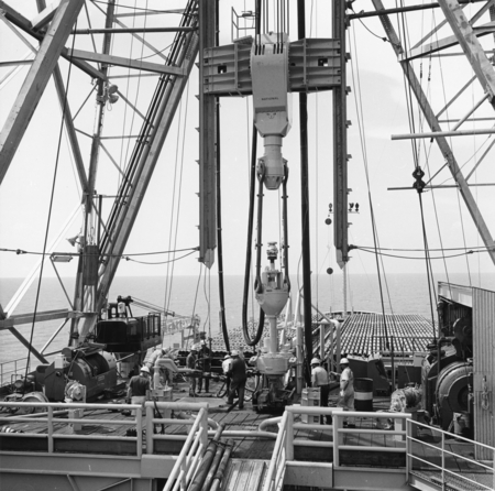 Glomar Challenger drilling crew rigs hydraulically operated power sub, center, preparatory to commencinig drilling and cor...