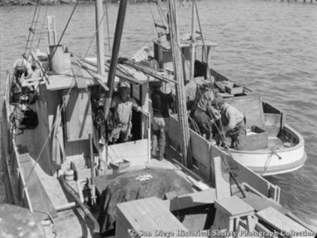 Fishermen on docked fishing boats