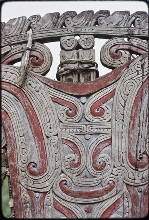 Canoes: detail of carved and painted splashboard of kula canoe, includes two witch figures (top)