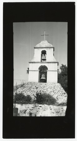 Woman in front of the bell tower at Pala Mission