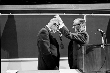 William D. McElroy receiving medallion of office from Charles J. Hitch during inauguration ceremony