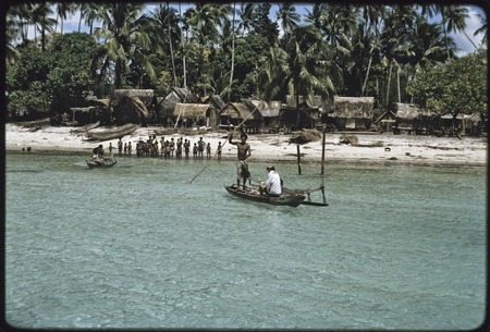 Kaileuna Island: village houses, people gathered on beach, Edwin Hutchins (in white shirt) on canoe