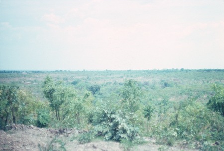 View of landscape surrounding Kaputa village, with buildings on the horizon
