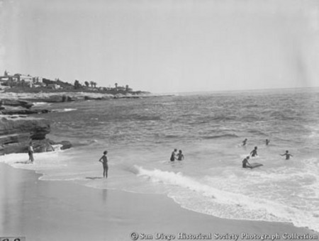 People in ocean surf at La Jolla beach