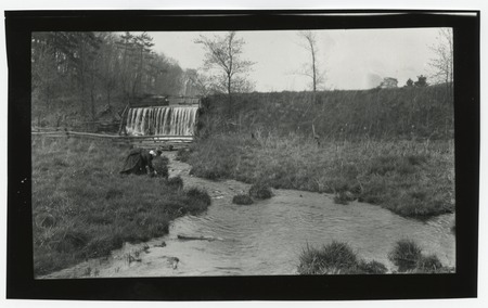 Unidentified waterfall and river with woman in foreground