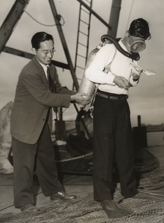 Japanese oceanographer Noriyuki Nasu (left) shown here assisting a Japanese aqualung demonstrator, Nasu later worked at th...