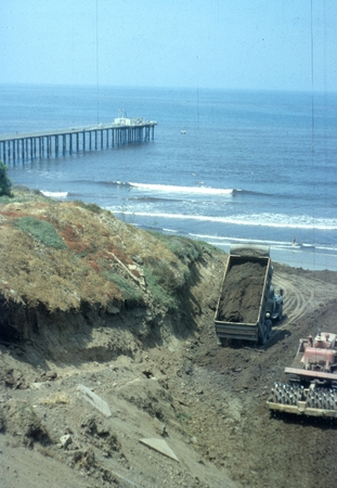 Looking at the Scripps wooden pier and the dirt removal being done in front of building T-28 on the campus of Scripps Inst...
