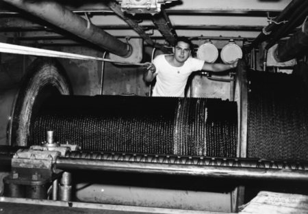 William C. King (&quot;Buddy&quot;) stands behind the drum holding 40,000 foot tapered steel cable, R/V Spencer F. Baird