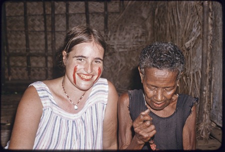 Dona Hutchins and her putative mother, Bomtavau, chewing betel nut, Hutchins has streaks of red betel nut paste on her cheeks