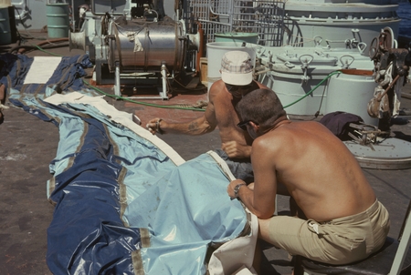Scientific members of the Swan Song Expedition (1961) are shown here sewing the &quot;sampler&quot; water collection bag. This exped...