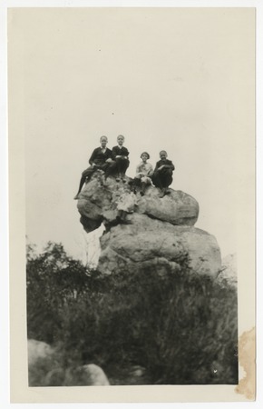 Children perched on boulders