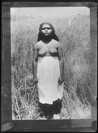 Young Australian Aboriginal woman in a field | Library Digital Collections  | UC San Diego Library