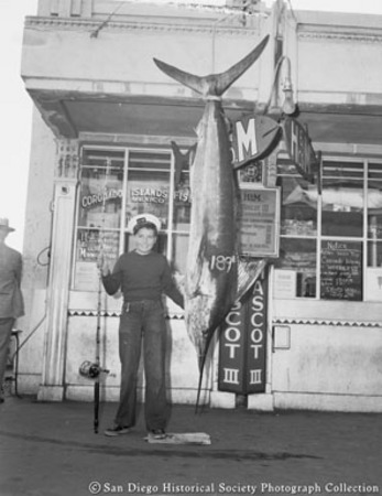 Ralph Miller Jr. posing with marlin catch at H &amp; M Sport Fishing