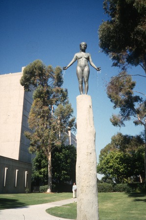 Standing: detail view of cast tree and nude figure with UCSD School of Medicine in background