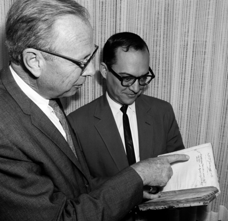 Melvin Voigt and Ronald Silveira with rare book