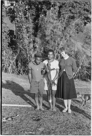 Large lizard, held by interpreter Kavali, flanked by Gana (l) and Ann Rappaport (r)