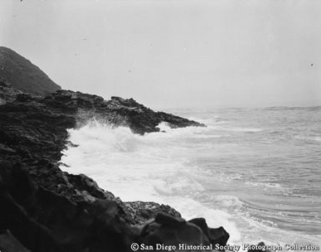 Waves crashing on rocky coastline [of Coronado Islands?]