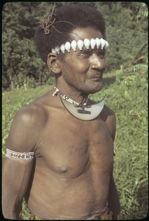 Man with dafi on neck and tale&#39;ekalango on forehead.