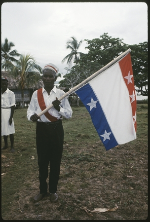 Christian Fellowship Church member holding a flag