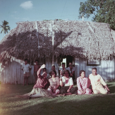 Family group in front of a beach fale, Fiji