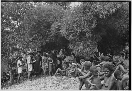 Church service in Kwiop: Solomon Islander mission workers read to crowd of Kwiop people