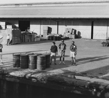 Three men on dock at Suva, Nova Suva end of Leg IV