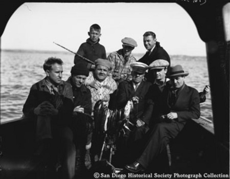 Babe Ruth and others posing at stern of boat with catch of fish