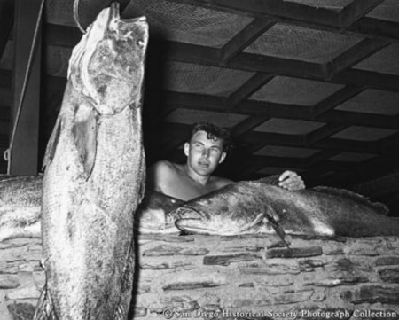 Man weighing catch of tuna