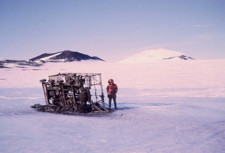 Paul Dayton with burned Trackmaster which flipped over in a USN accident on the sea ice, near McMurdo Station, Antarctica....