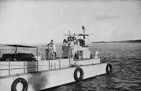 Martin W. (Martin Wiggo) Johnson in helmet (center) shown here on a landing craft during the Capricorn Expedition (1952-19...