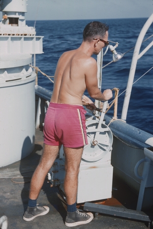 Jan B. Lawson of the Scripps Institution of Oceanography&#39;s Swan Song Expedition (1961) is shown here lowering the bathythe...
