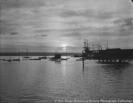 San Diego waterfront at sunset, sailing ships docked at Spreckels Brothers Commercial Company coal bunker wharf