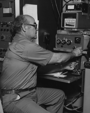 Art Arroyo, the radio operator for the D/V Glomar Challenger (ship), attempting to make ham radio patches for the members ...