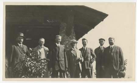 Group of unidentified men standing on the porch of Pine Hills Lodge