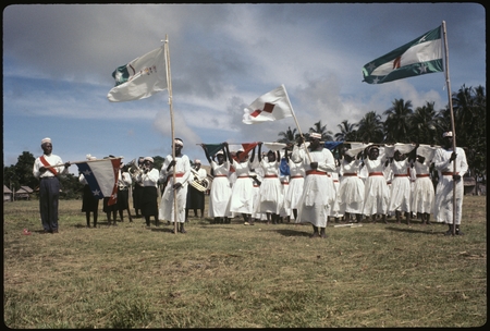 Group holding Christian Fellowship Church flags; band also present