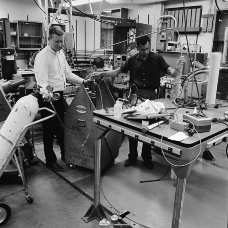 Michael Malley (left) and unidentified men in Physics Laboratory, 1205 Mayer Hall, UC San Diego