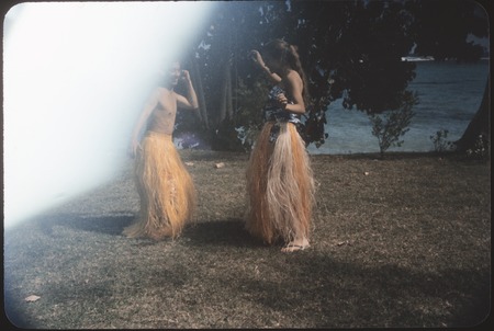 Yosihiko Sinoto and Ann Rappaport dance in grass skirts, Tahiti