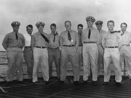 U.S. Navy personnel and civilian staff (Walter Munk, fourth from the left) topside near Bikini Atoll, during atomic testing