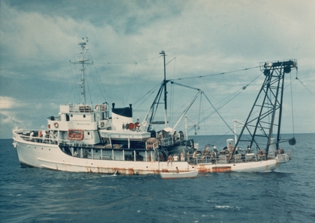Profile of R/V Spencer F. Baird at sea with a skiff nearby