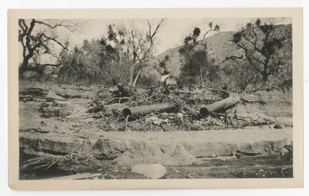 Lengths of steel pipe from the San Diego flume amid debris from the 1916 flood