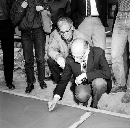 John Stewart watches as Jonas Salk writes his name in cement, Muir College, UC San Diego