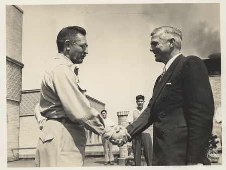 Claude M. Adams being awarded the Army Commendation Ribbon by Hubert G. Schenck, for alleviating Japan&#39;s food shortage by ...